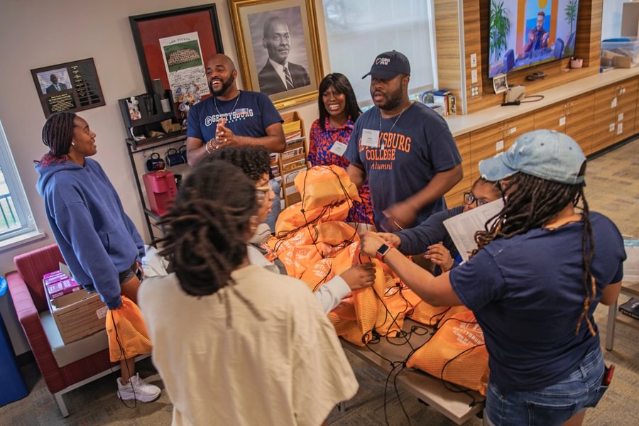 Alumni assemble and distribute finals care packages to students.